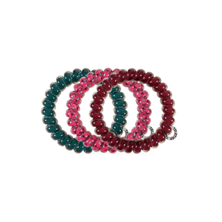 Four spiral coil hair ties with beaded texture, arranged in an overlapping oval display.