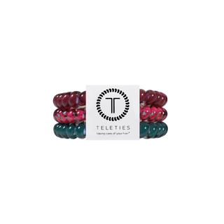 Three spiral coil hair ties stacked together with TELETIES branded packaging card.