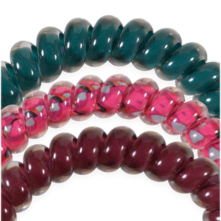 Three coiled TELETIES small hair ties with rondelle-shaped beads in an arch formation against black background.