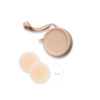 Beige silicone case with strap containing circular adhesive breast petals or nipple covers