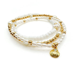 Infinity bracelet with white pearls, gold beads, and seashell charm pendant from Alegria Accessories