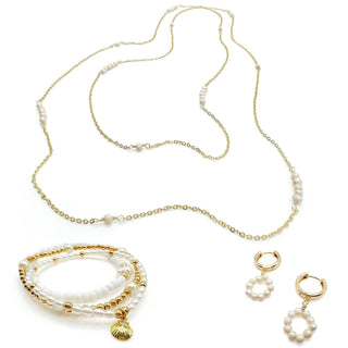 Gold and pearl jewelry set including long necklace, layered bracelet, and circular hoop earrings