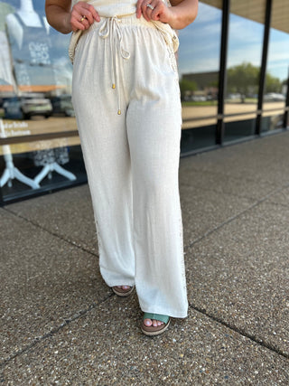 Allie Rose wide-leg linen pants with drawstring waist and lace side panel detail.