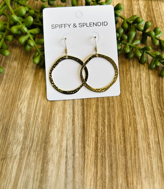 Spiffy & Splendid gold-plated circle hoop earrings displayed on white packaging card with green foliage decoration.