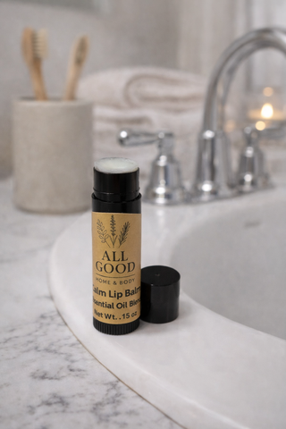 All Good Home & Body Calm Lip Balm with essential oil blend displayed on marble bathroom counter.