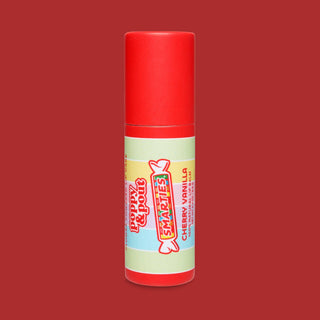 Red lip balm tube with colorful Smarties candy-themed label on gradient red background
