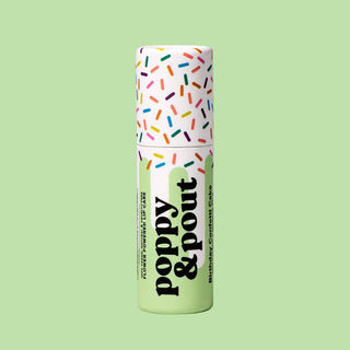Poppy & Pout lip balm tube with colorful sprinkle design on green background