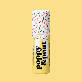 Poppy & Pout lip balm tube with colorful sprinkle design on white cap against yellow background