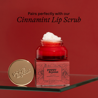 Poppy & Pout Cinnamint Exfoliating Lip Scrub jar with gold lid on red background