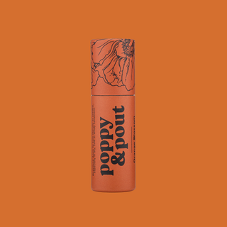 Orange cylindrical lip balm tube with floral design and black text on orange background