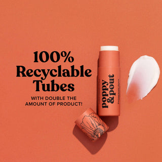 Poppy & Pout lip balm tube with white cap on coral background, featuring 100% recyclable packaging claim