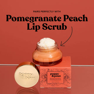 Poppy & Pout Pomegranate Peach lip scrub jar with gold lid next to product packaging box