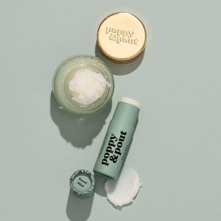 Poppy & Pout lip care products including lip scrub jar and lip balm tube with Sweet Mint labeling.