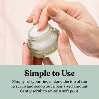 Hands holding open jar of lip scrub with white cream texture, demonstrating product application method.