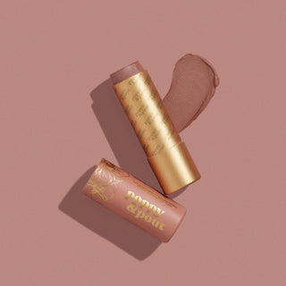 Poppy & Pout Charlie lip tint with gold tube and pink packaging on rose background