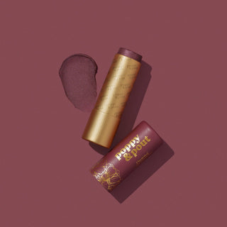 Poppy & Pout Donna lip tint with golden tube and burgundy packaging on matching background
