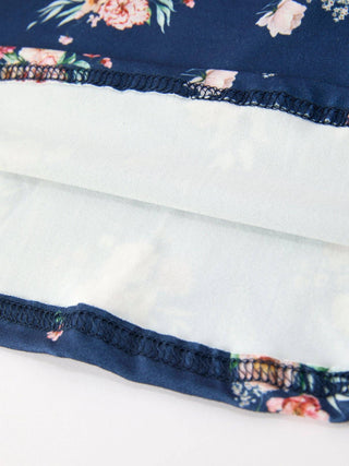 Close-up of floral dress lining showing navy fabric with pink blooms and serged seams.