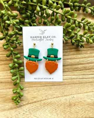 Lucky Leprechaun earrings with green top hats and orange beards on Harper Klay Co card with greenery