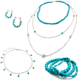 Turquoise beaded jewelry set including necklaces, bracelets, earrings and anklet with silver accents displayed together.