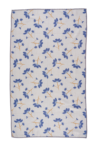 White kitchen towel with blue floral pattern and orange stems on light background