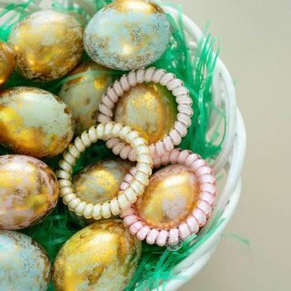 TELETIES Meadow Mist hair ties displayed in basket with decorative Easter eggs and green grass