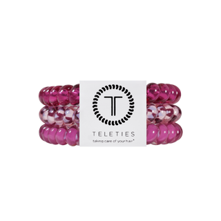 Three spiral coil hair ties in jewel-toned shades, stacked together with TELETIES branding card.