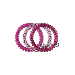 Four TELETIES spiral hair ties with beaded texture, featuring solid and patterned designs, displayed overlapping.