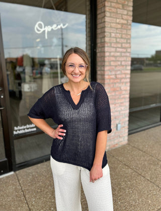 Woman smiling outside boutique wearing Blu Pepper Midnight Dream Crochet Top with white pants.