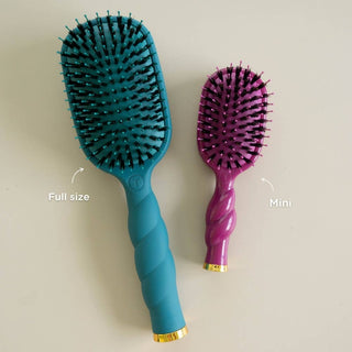 Two TELETIES vented paddle hair brushes displayed side by side showing full size and mini size comparison.
