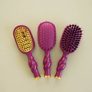 Three TELETIES Mini Vented Hair Brushes with twisted handles and gold accents displayed on neutral background.