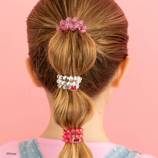 Back view of ponytail styled with colorful Minnie Mouse themed hair ties against pink background.