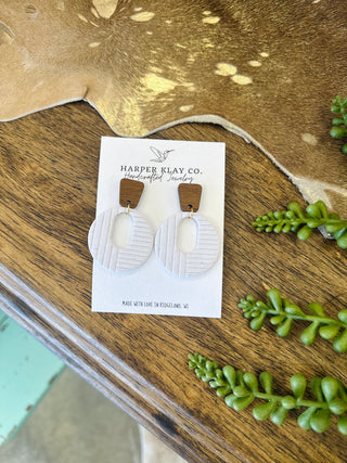 Harper Klay Co. handcrafted clay circle drop earrings with wood stud tops on display card.