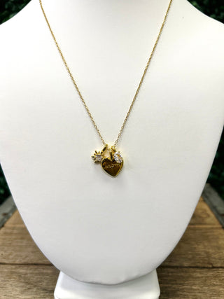 Gold charm necklace with heart pendant and sun charm displayed on white jewelry bust