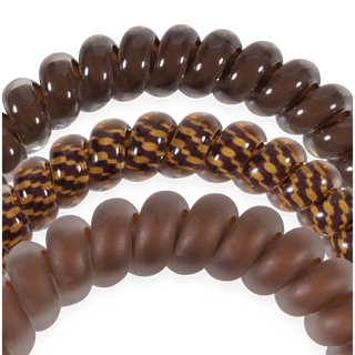 Three TELETIES small hair ties in glossy, patterned, and matte finishes arranged in an arc shape.