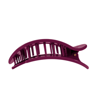 Large flat round hair claw clip with open grid design and gold pivot hardware.