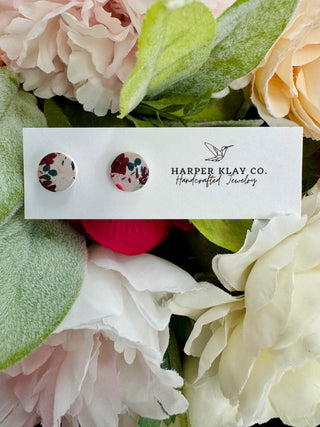 Harper Klay Co Mulberry Meadow stud earrings on white card surrounded by colorful artificial flowers