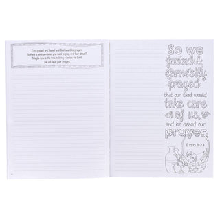 Open prayer journal showing lined writing page and coloring page with biblical verse from Ezra 8:23