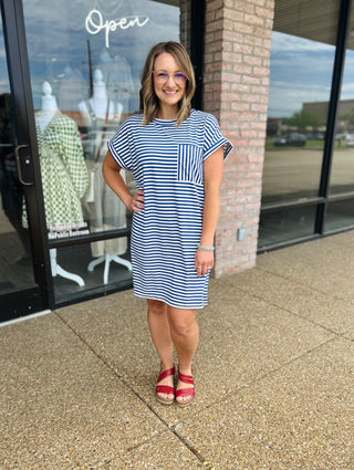 Woman wearing Haptics striped t-shirt dress with chest pocket, paired with platform sandals.
