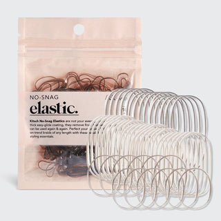 Clear no-snag elastic hair ties displayed next to pink packaging on white background