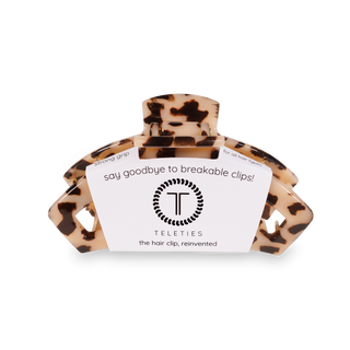 TELETIES tortoiseshell hair clip with product packaging showing brand logo and marketing text