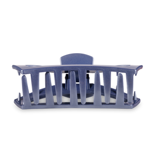 Large open hair clip with curved design and slotted sides in translucent blue material