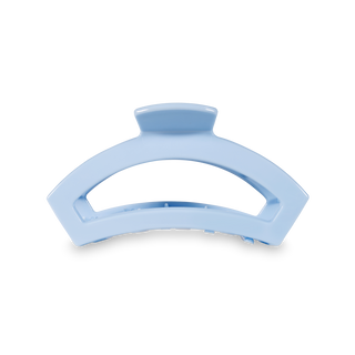Clear blue curved hair clip with open design and textured grip surface