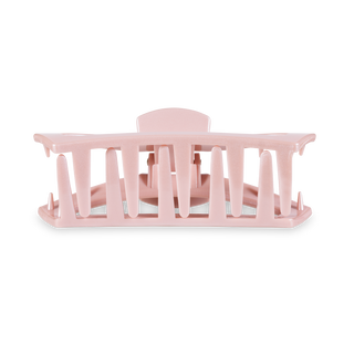 TELETIES open hair clip in translucent pink displayed on clear plastic packaging against white background.