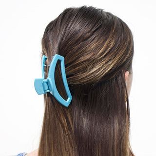 TELETIES open hair clip holding back brown highlighted hair against white background