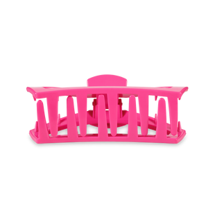 Pink plastic hair clip with open slotted design for securing hair