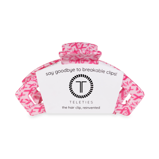 Pink patterned hair clip with TELETIES branding and "say goodbye to breakable clips" text