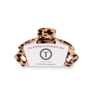TELETIES tortoiseshell hair clip with white product label against black background