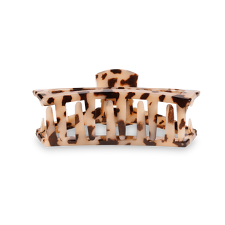 TELETIES open hair clip with tortoiseshell pattern featuring comb-like teeth design on black background