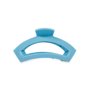 Light blue curved open hair clip with knob closure on transparent background