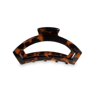 TELETIES open hair clip in tortoiseshell pattern against black background